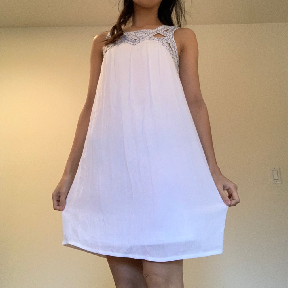 White dress with high neckline & blue embroidery